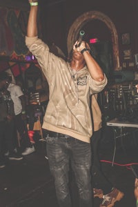 a man holding a microphone in front of a crowd